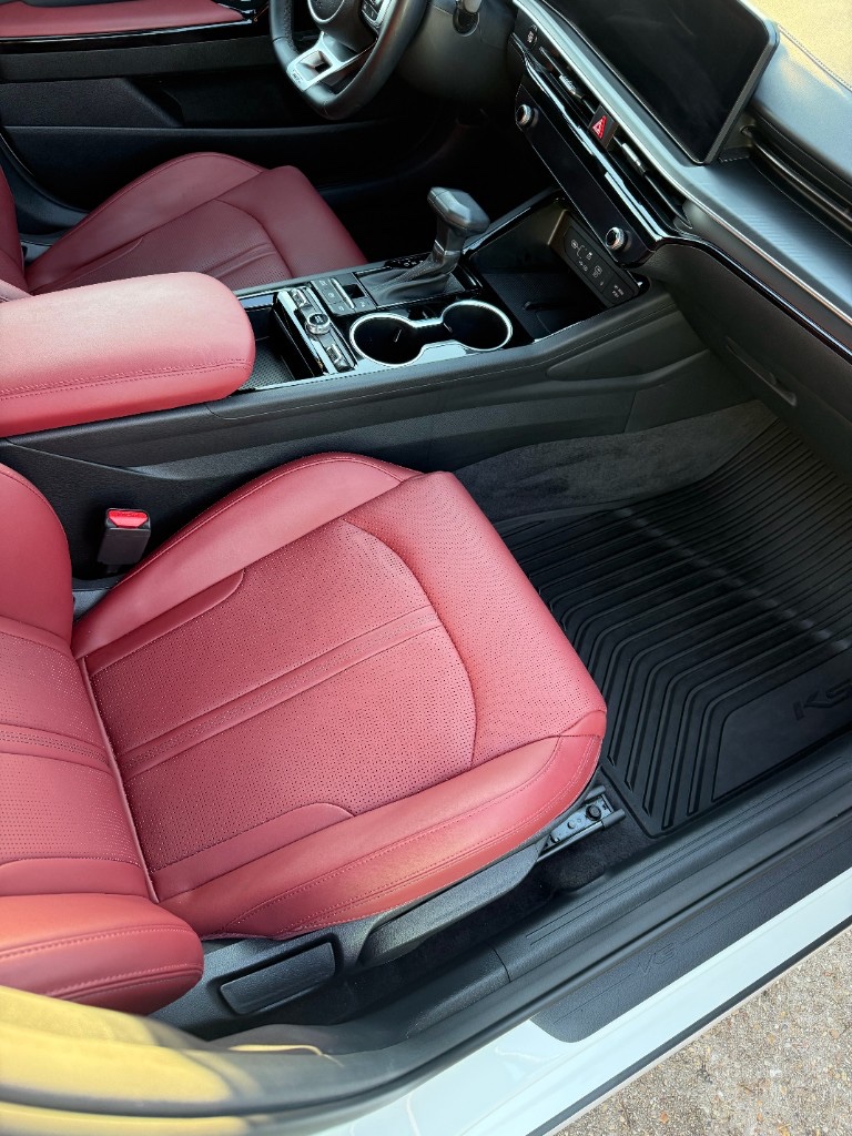 Kia K5 passenger interior after detailing — red seats and clean console